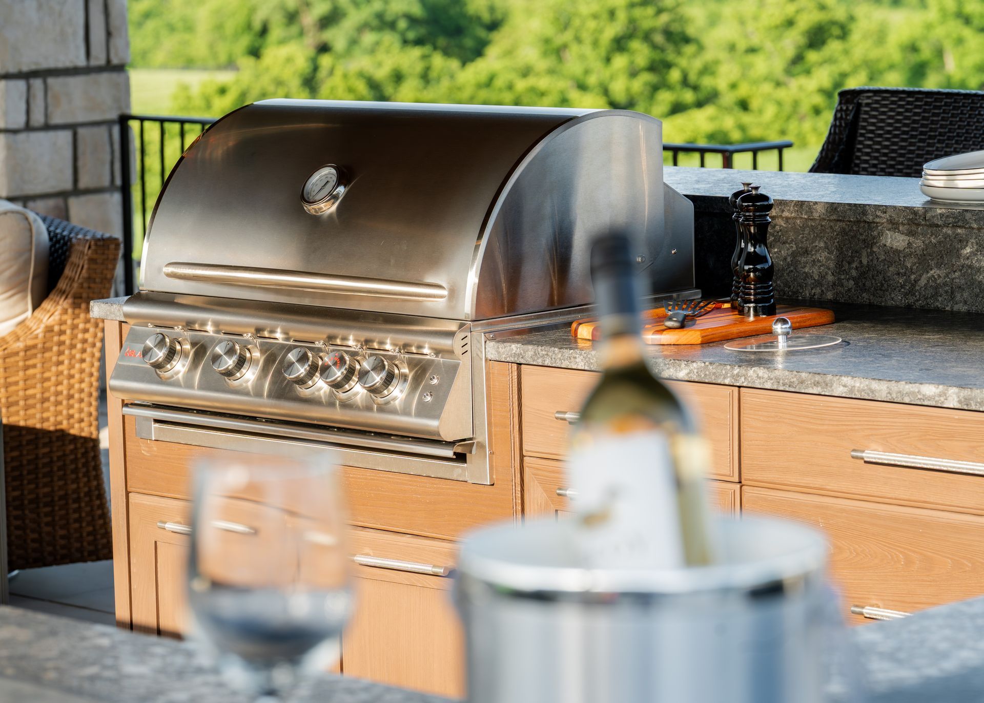 A stainless steel grill is sitting on top of a wooden table.