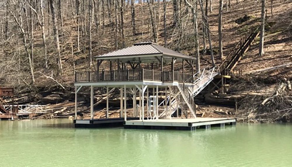 Single slip sundeck boat dock. Burnished slate roof, posts and railing - Dock Solutions of Kentucky | Lexington, KY