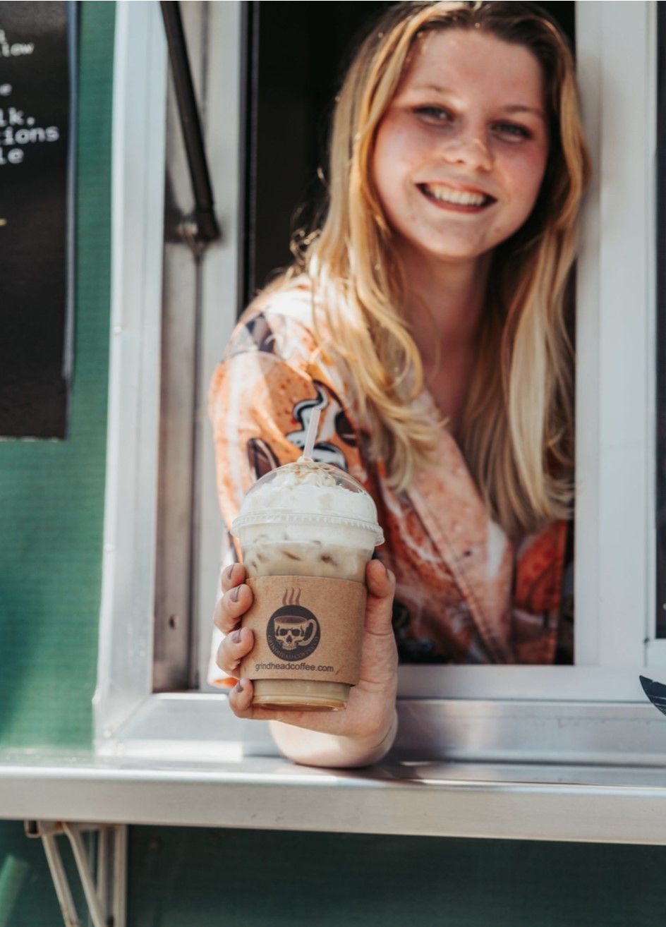 Woman holding a Cold Coffee - Grindhead Coffee - Chattanooga, TN