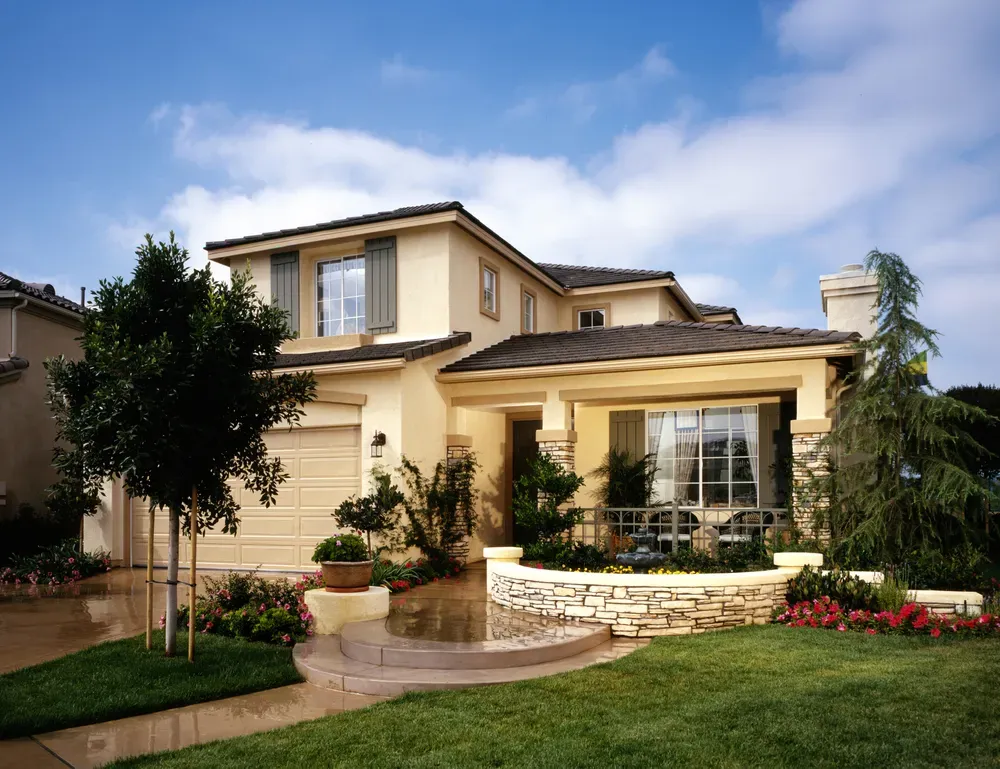 A large house with a lush green lawn in front of it