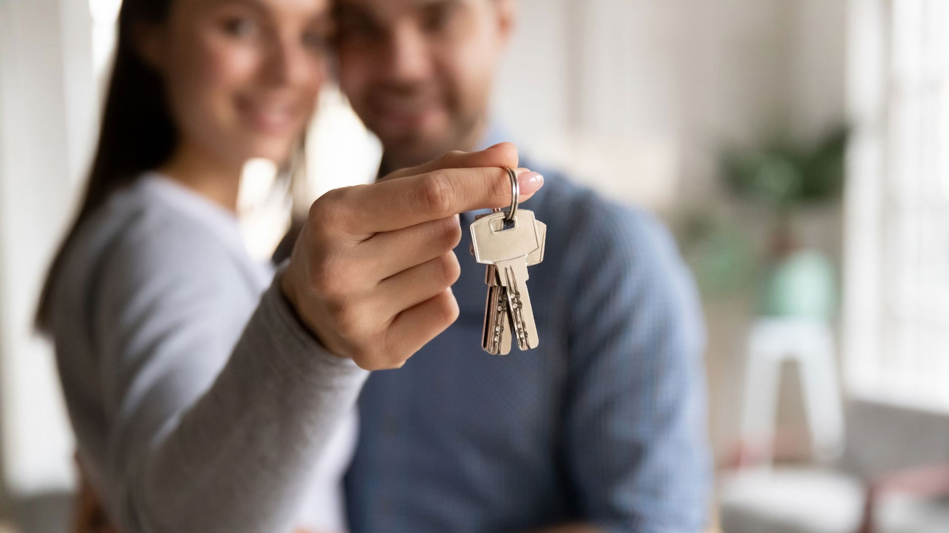 Photo of a couple holding keys