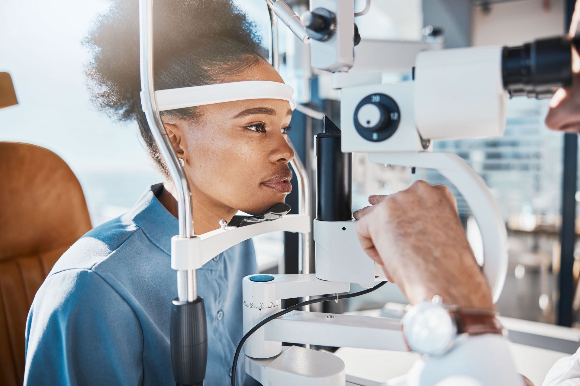 A woman is getting her eyes examined by an ophthalmologist.