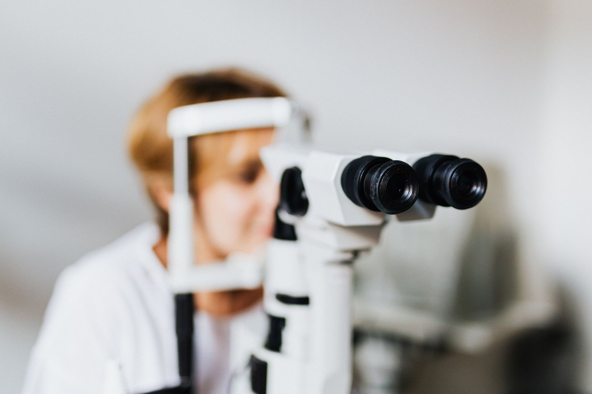A woman is getting her eyes examined by an ophthalmologist.