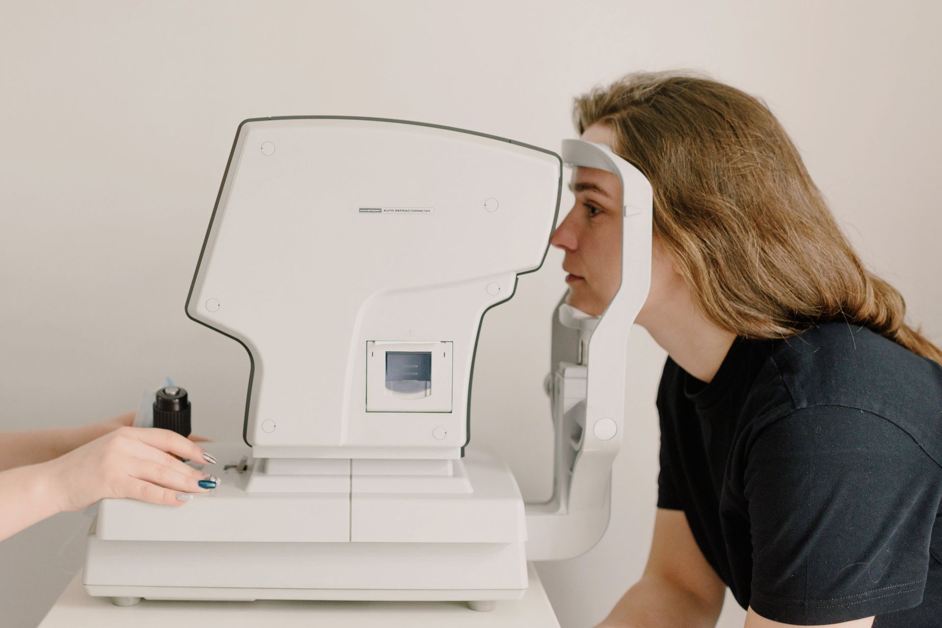 A woman is getting her eyes checked by an ophthalmologist.