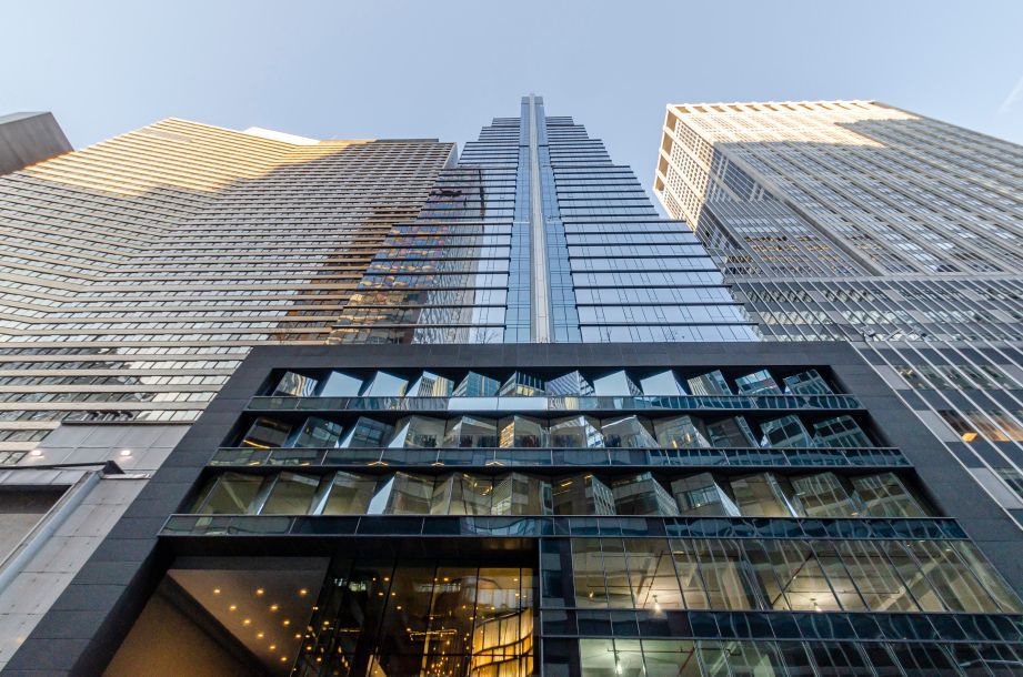 Low-angle view of modern glass skyscrapers against the sky
