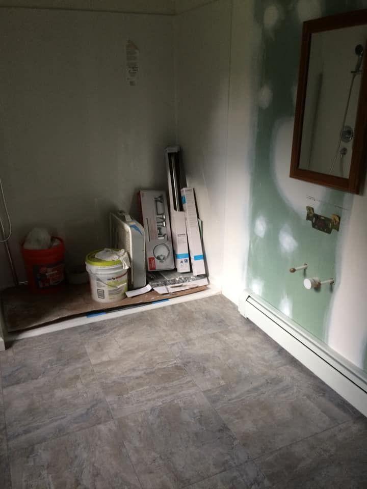 A room with a tiled floor and a mirror on the wall.