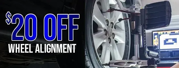 A wheel alignment machine attached to a car tire with bold text reading 