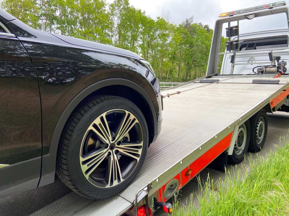 A Car Is Being Towed By A Tow Truck — Tim's Towing and Transport In Lambs Valley, NSW