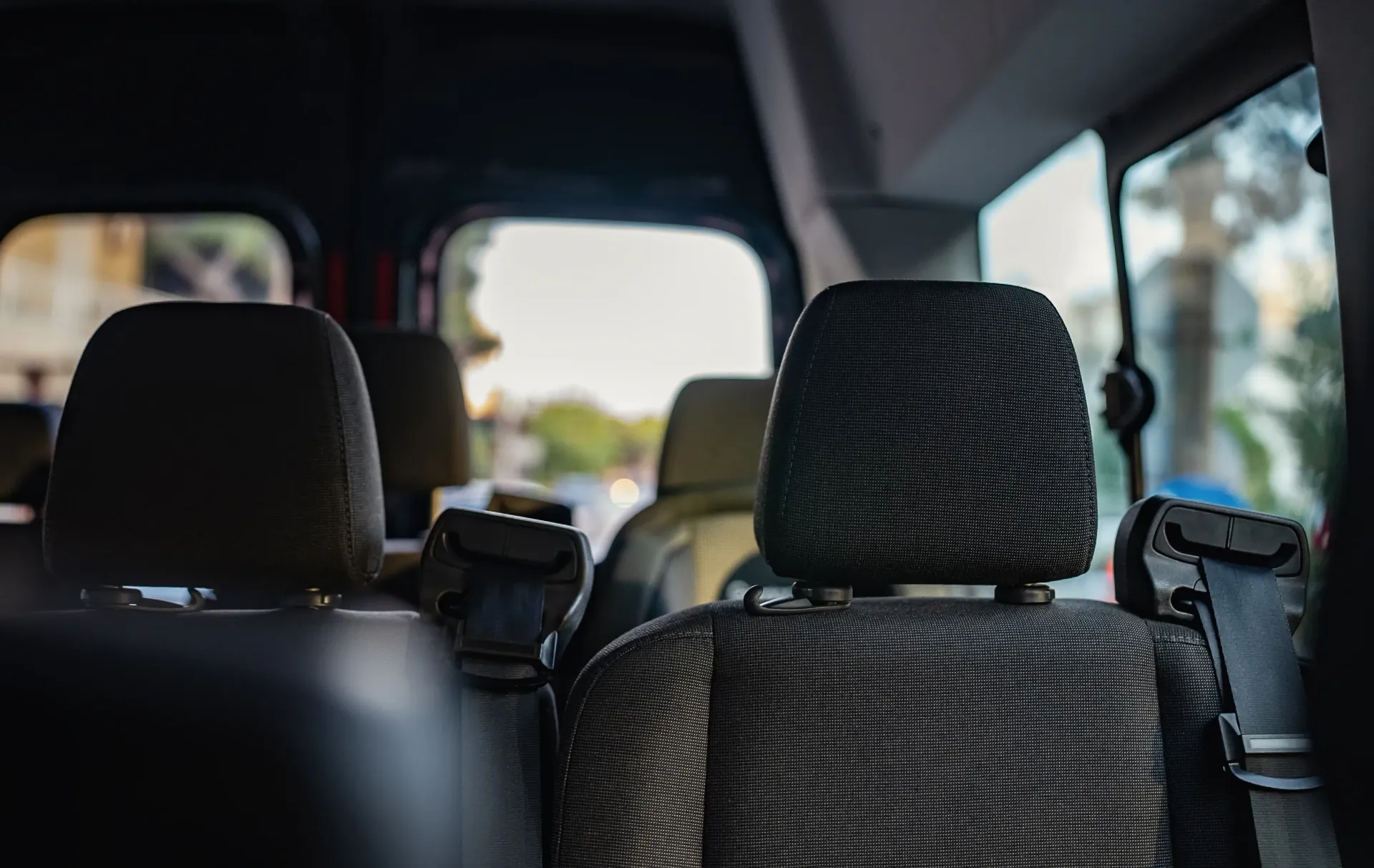 Interior of a van with patterned seat covers for private shuttle Cleveland residents can book.