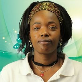 Woman in white polo with headband, facing forward against a green background.