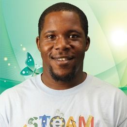 Smiling man in a white T-shirt against a green background with a butterfly graphic