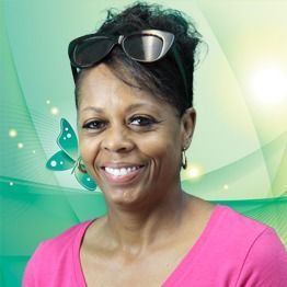Smiling woman in pink top with sunglasses on head, against a green abstract background with butterfly accents