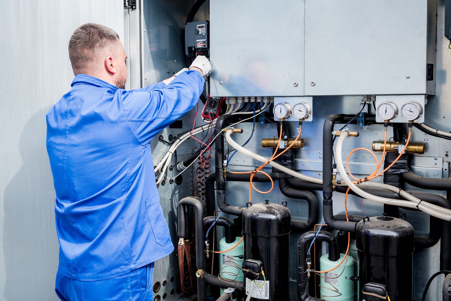 Technician performing maintenance on a commercial refrigeration unit in a Bensalem, Pennsylvania.