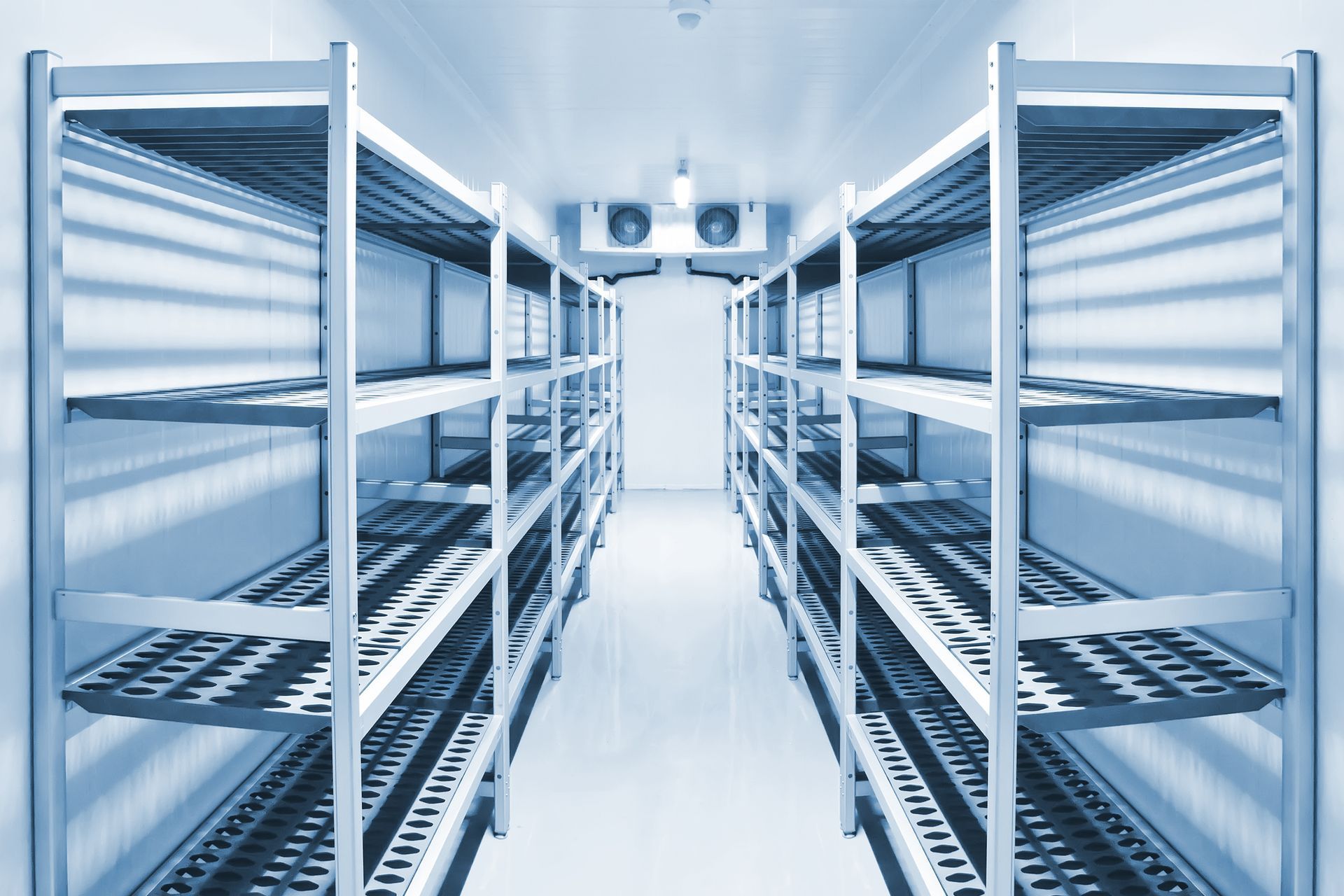 Philadelphia technician inspecting commercial refrigeration unit during winter maintenance.