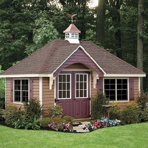 A small house with a weather vane on top of it
