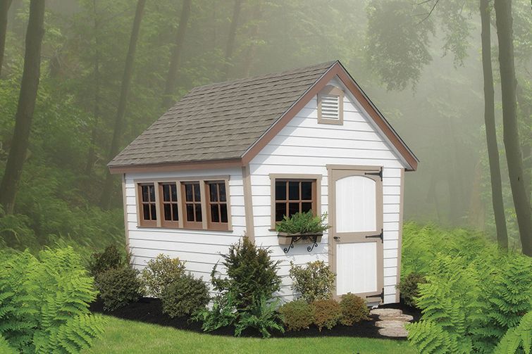 A small white house in the middle of a forest A small white house in the middle of a forest