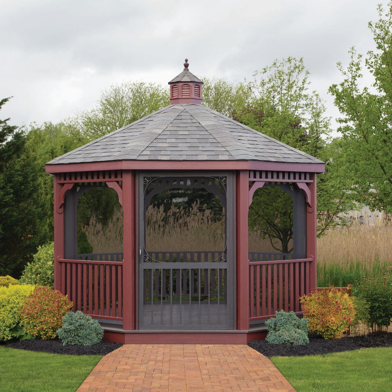 A gazebo with a table and chairs in the middle of a grassy field