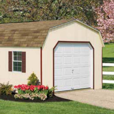 Tan shed with three windows, oval window, and shingled roof, set against trees.