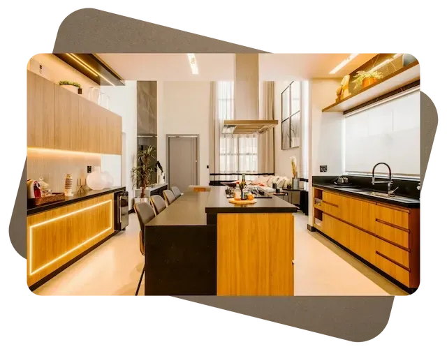 Modern kitchen with wood cabinets, black countertops, central island, and warm lighting