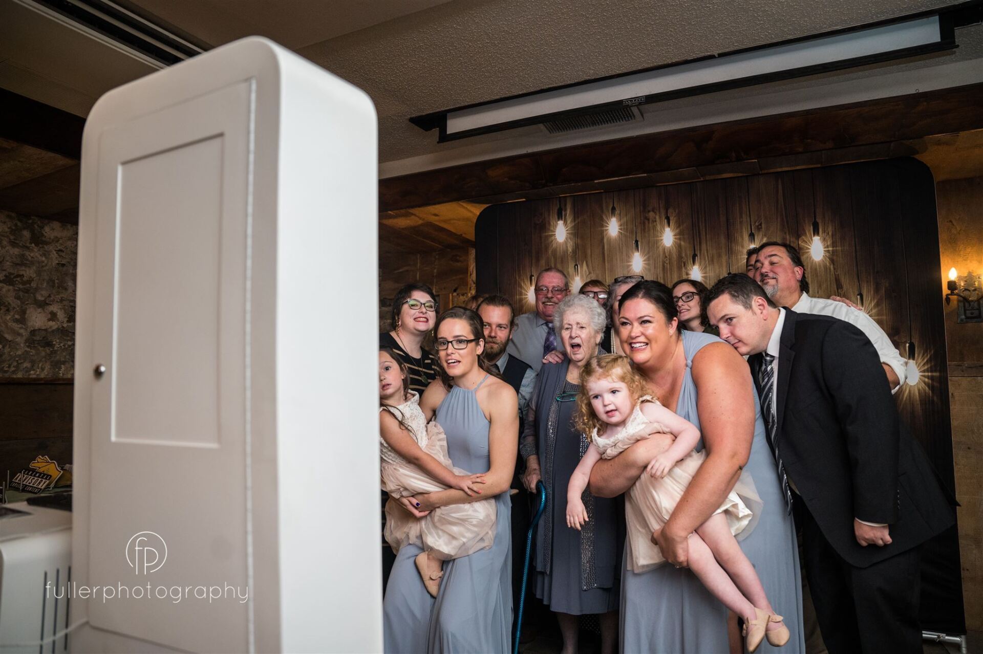 wedding guests in photo booth 