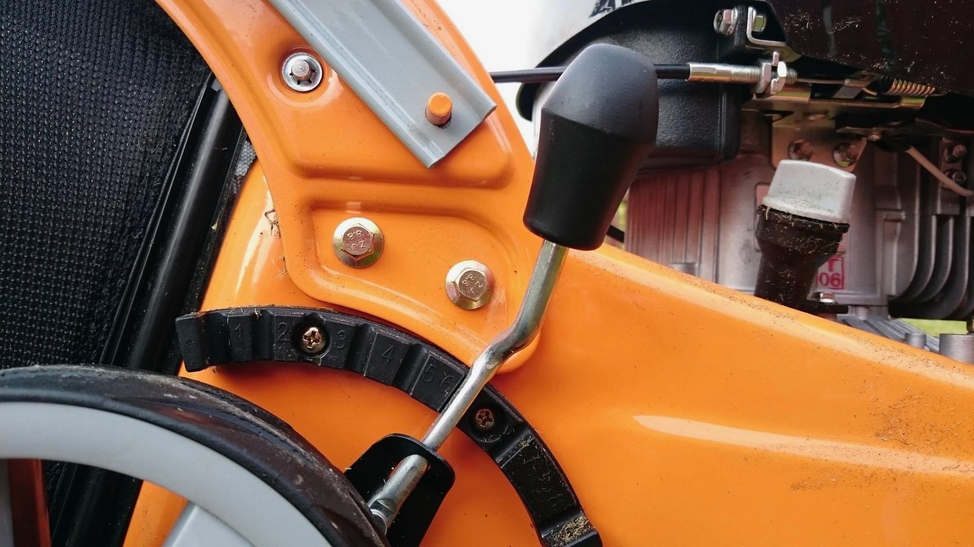 Photograph of the height adjustment mechanism, fitted to a Cyril Johnston Tiger brand, 16 inch, petrol powered mower. 