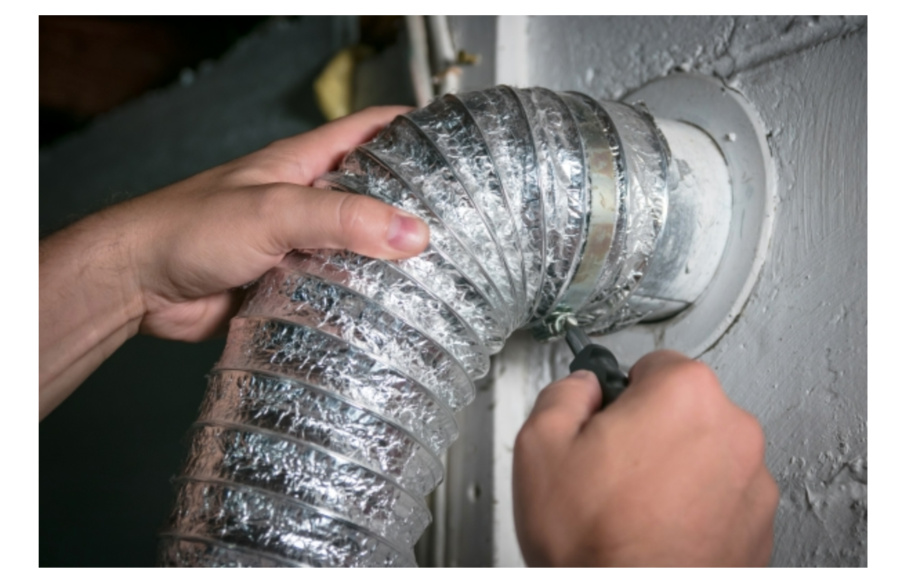 A person is fixing a duct with a screwdriver.