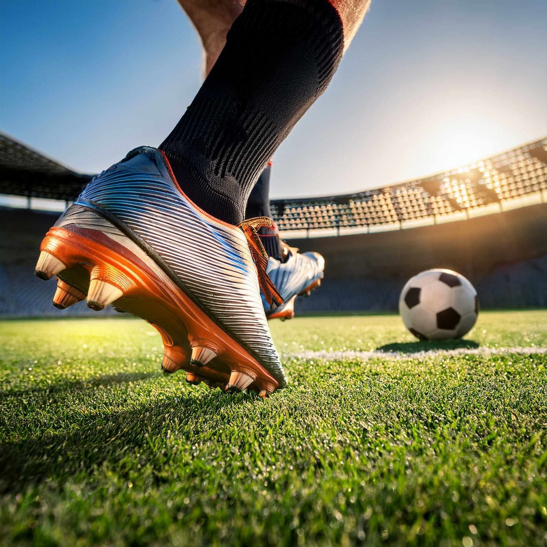A man playing soccer on an artificial turf sports field