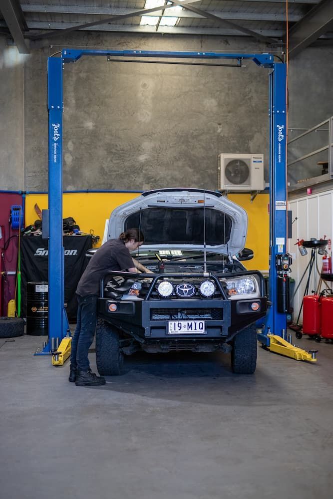 A Fitter Repairing a Service Vehicle — MADD Mechanical in Paget, QLD