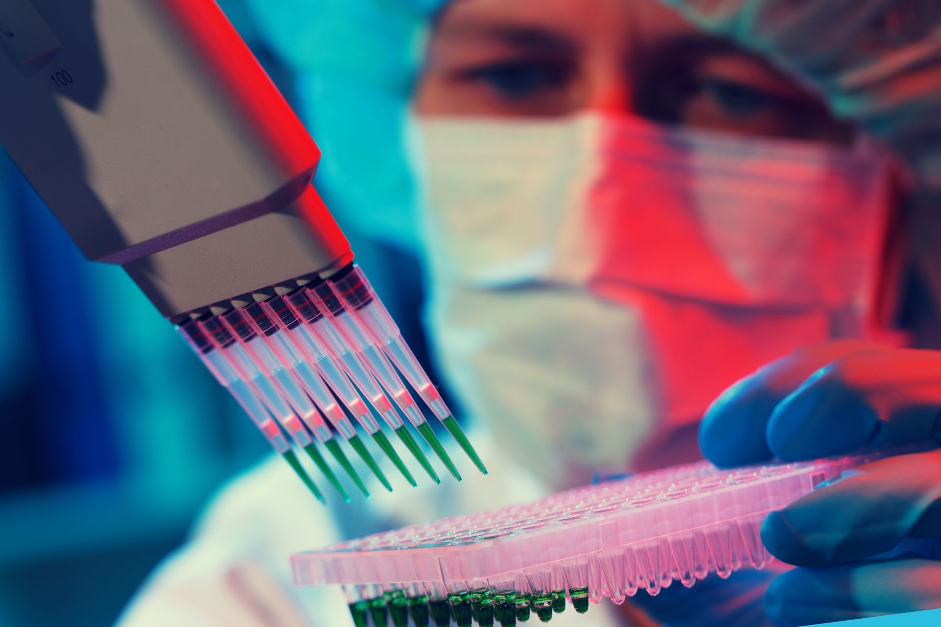 A scientist wearing a mask and gloves is using a pipette
