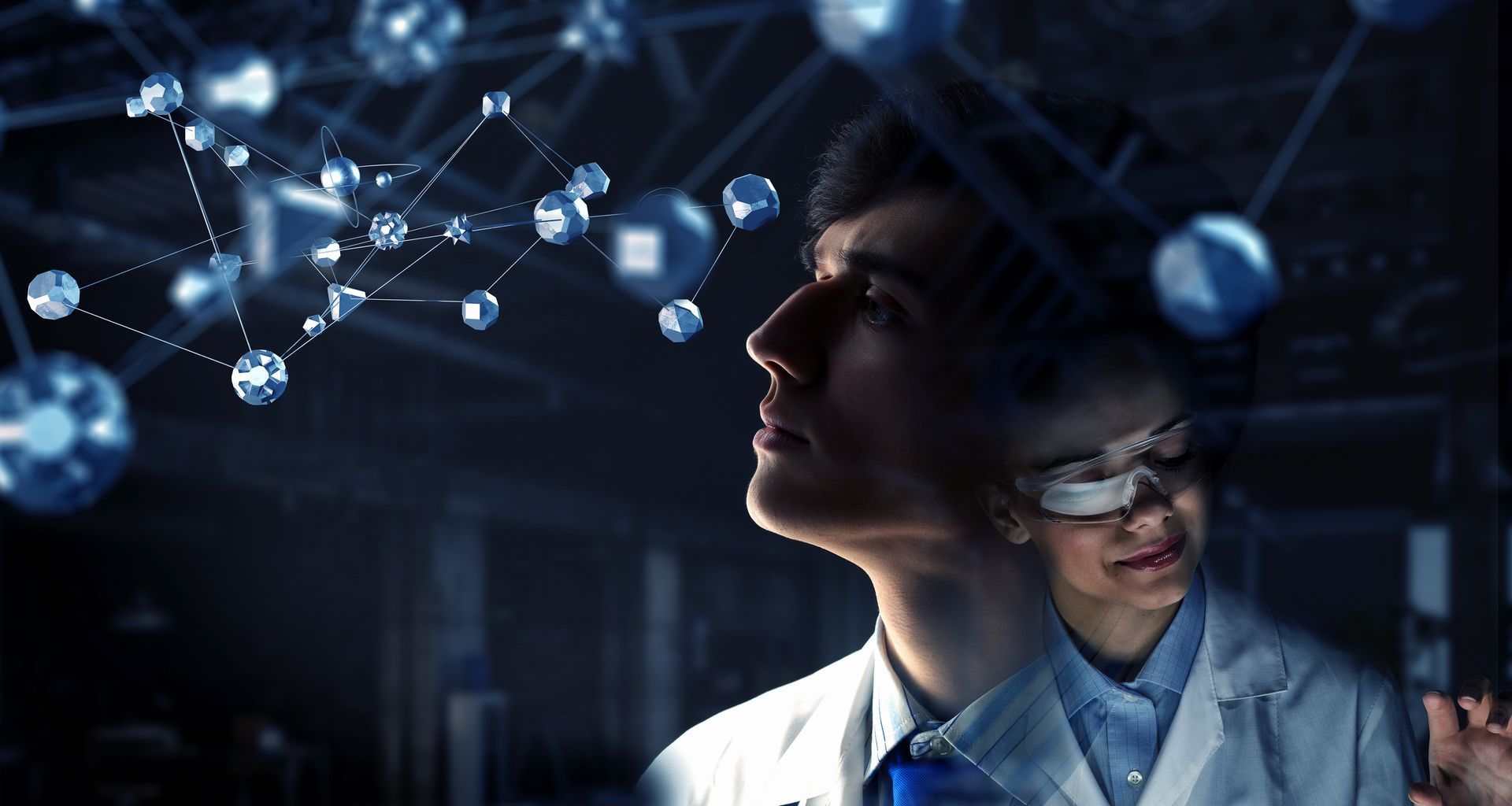 A man and a woman are looking at a screen with molecules coming out of it.