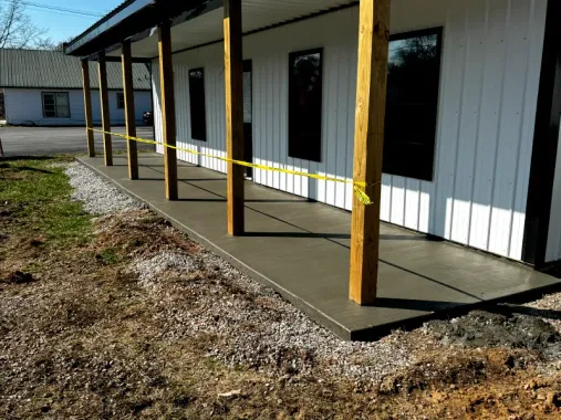 A concrete porch is being built on the side of a building.