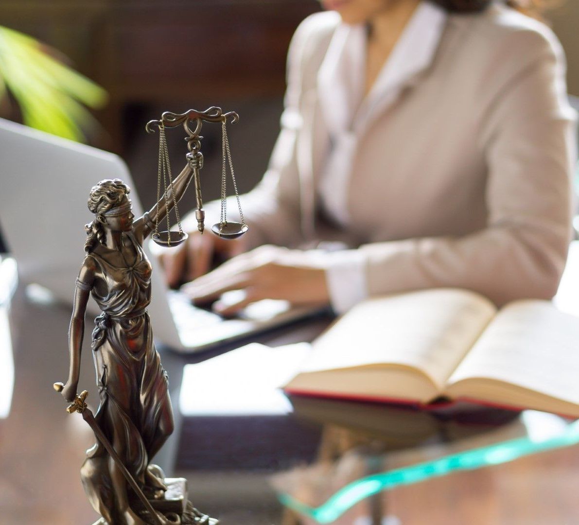 DUI Defense Lawyer in Renton, WA with scales of justice and legal documents in an office