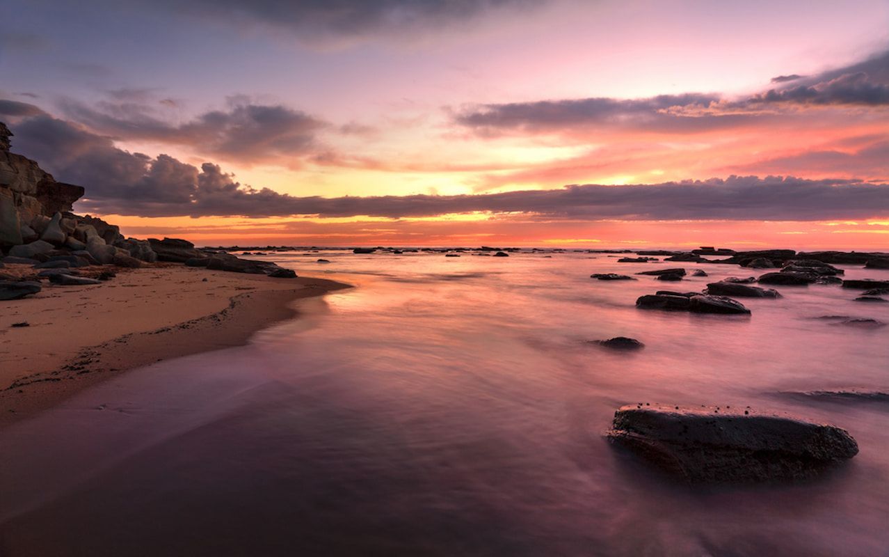 A Sunset Over a Beach with Rocks in The Water — Framing Alternative in Bateau Bay, NSW