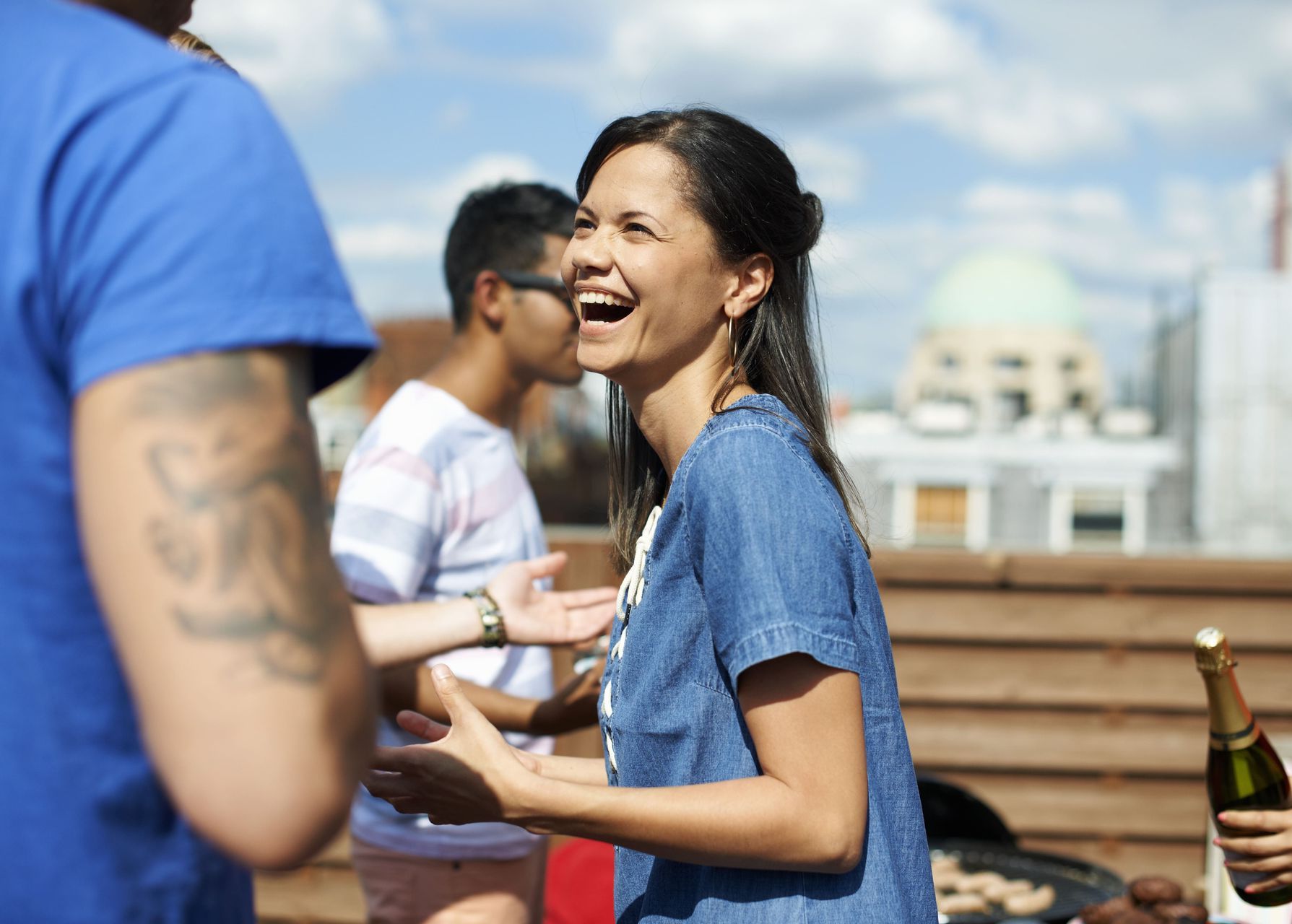 A group of people are having a party on a rooftop.
