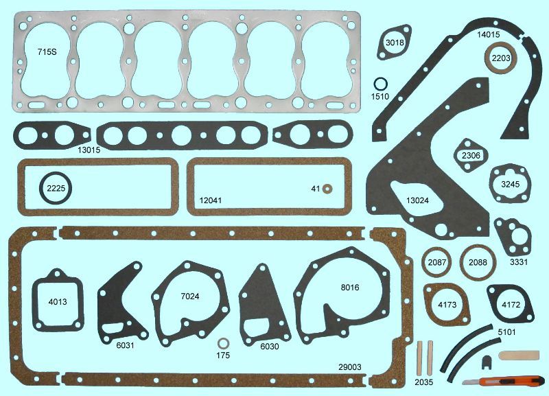 Various automotive exhaust gaskets and rings laid out on a wooden surface. Different shapes and sizes, mainly black and silver.