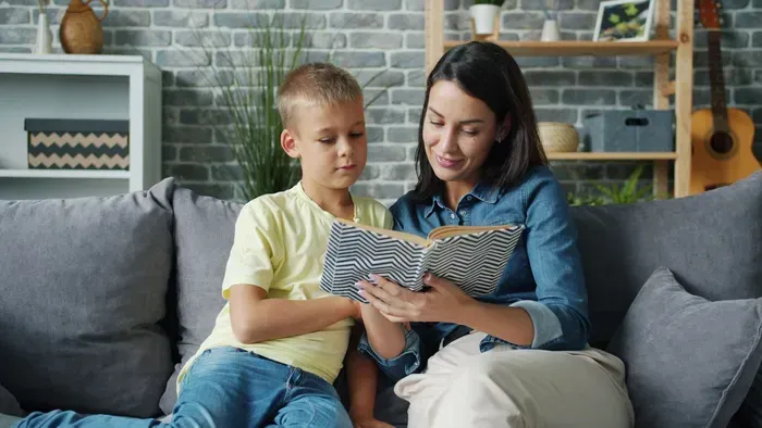 Nanny reading with two children