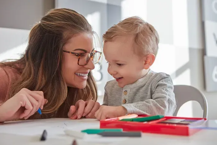 Nanny reading a book to a young child