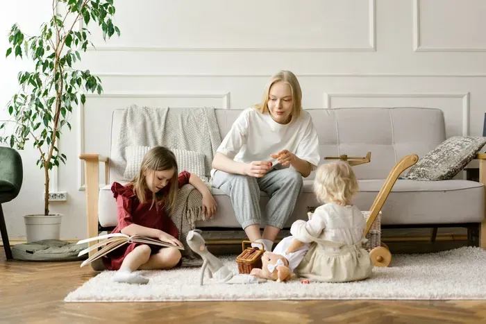 Nanny reading with two children