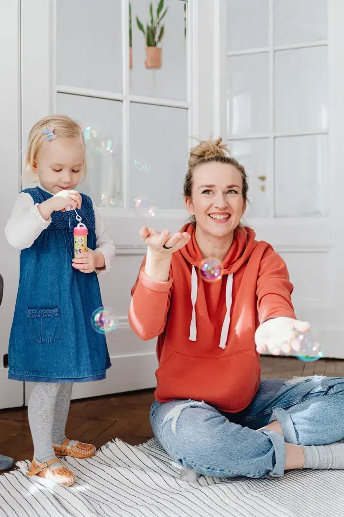 Nanny reading a book to a young child
