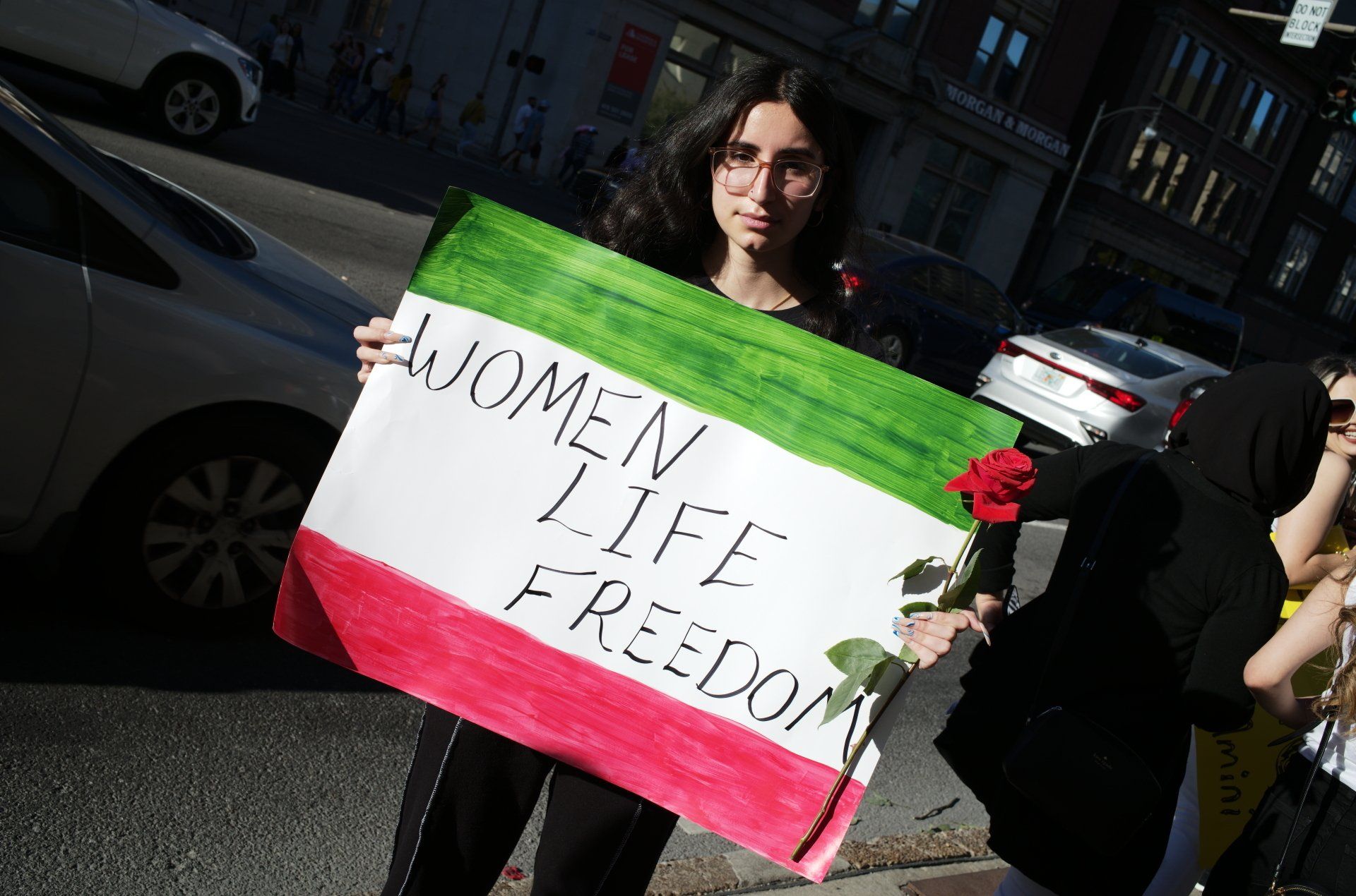Woman at rally with sign by ray di pietro
