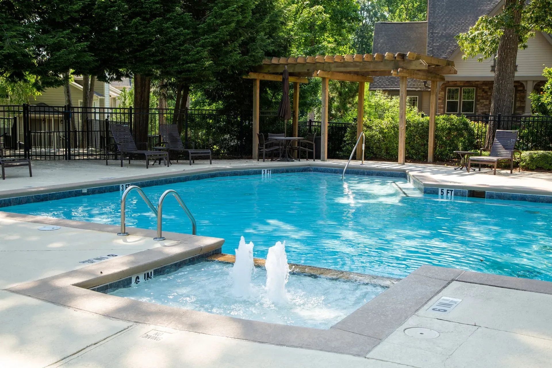 A man wearing a hard hat and gloves is working on an electrical box.