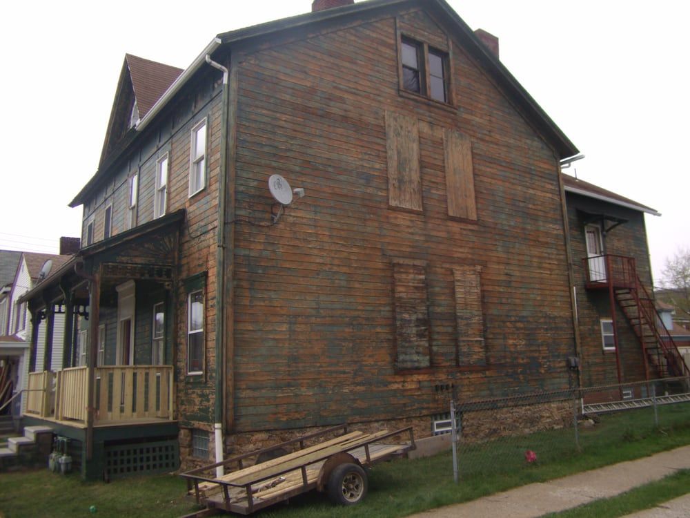 A house with a trailer parked in front of it
