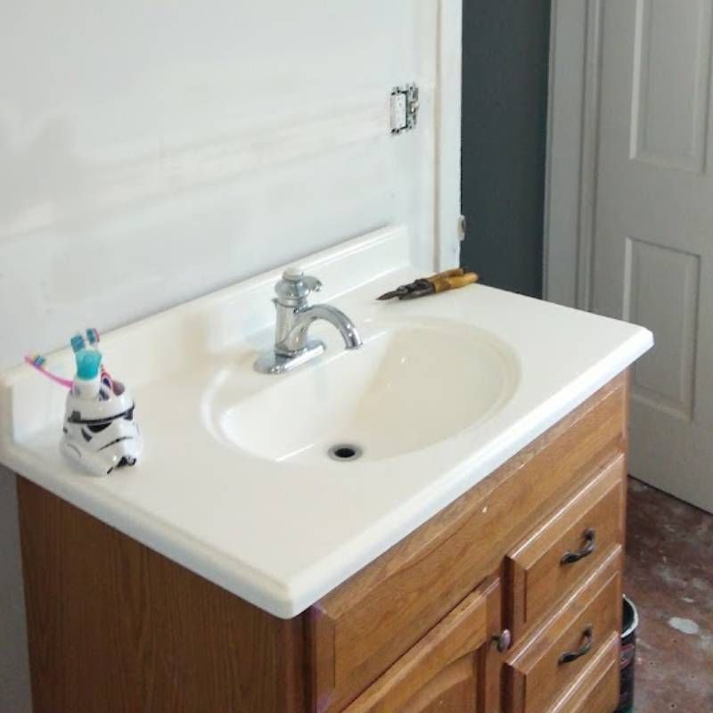 A bathroom sink with a storm trooper toothbrush holder