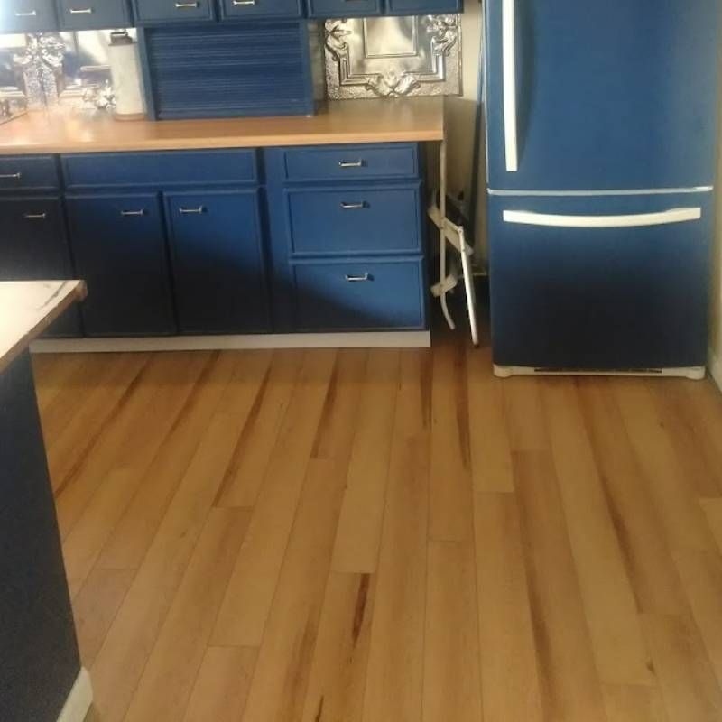 A kitchen with blue cabinets and a blue refrigerator