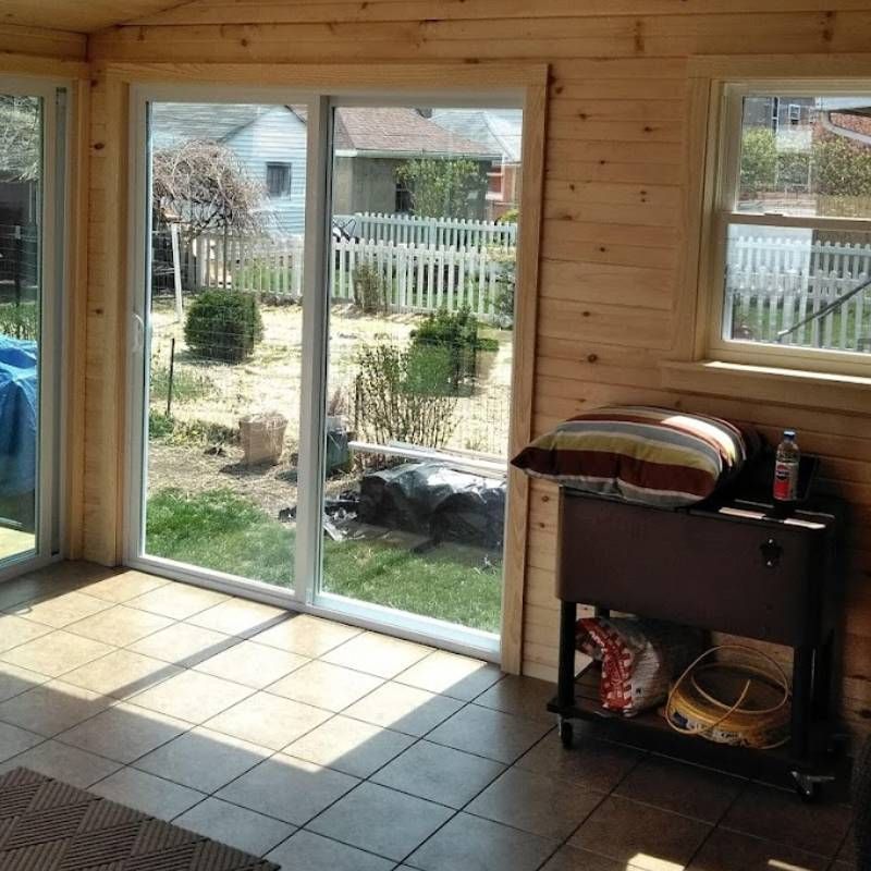 A room with a sliding glass door leading to a backyard