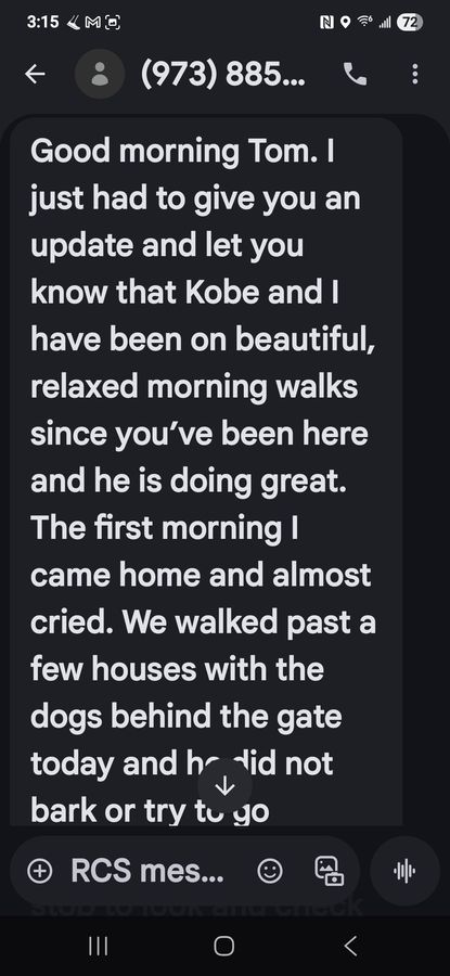 A phone screen showing a dark-mode text message about an update on Kobe and morning dog walking.