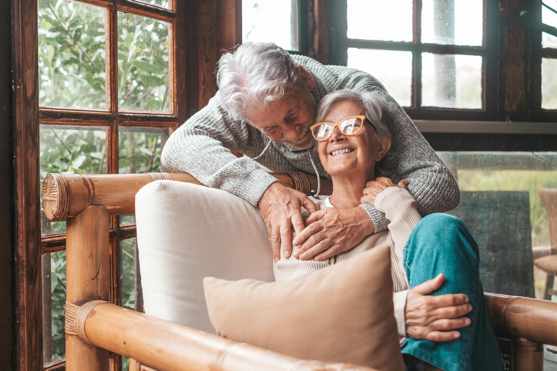 An elderly couple is sitting next to a fire drinking tea. Stock photo representing potential  guardianship client of bob leonard.