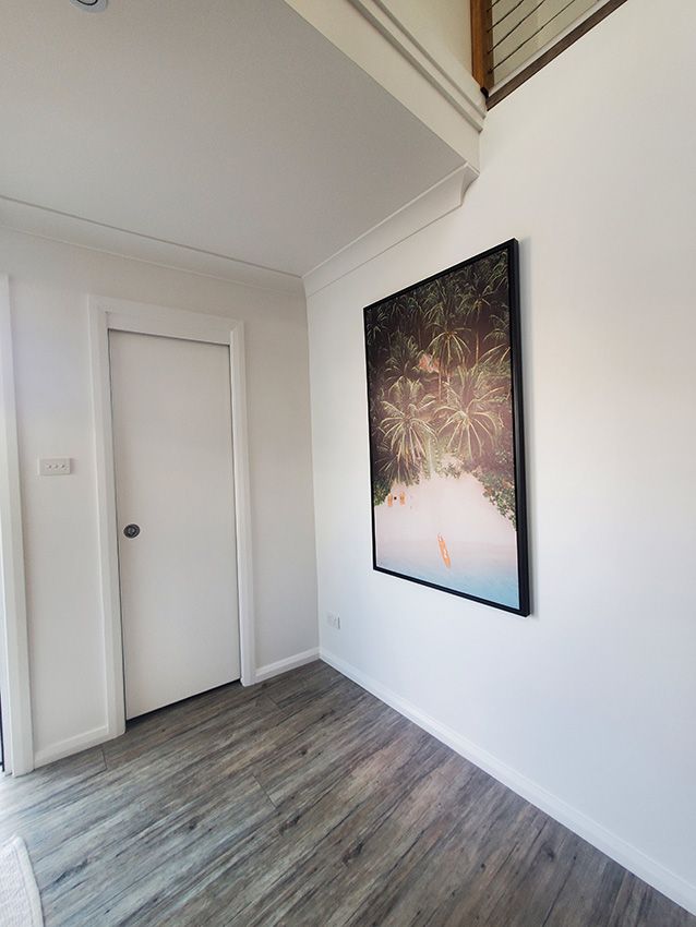 A Hallway with a Picture on the Wall and a Door — JWP Painting & Property Services in Sydney, NSW