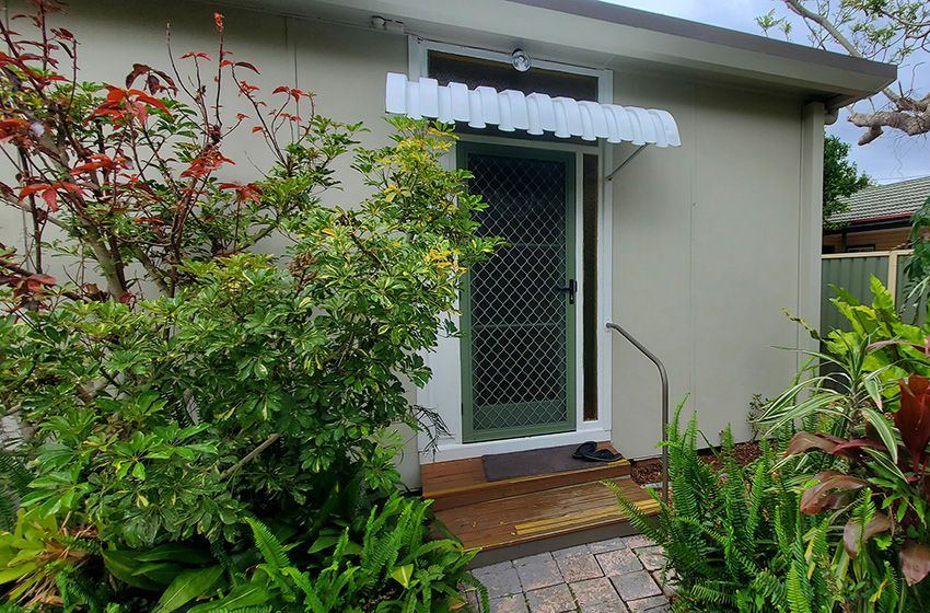 A Small House with a White Awning Over the Door — JWP Painting & Property Services in Bateau Bay, NSW