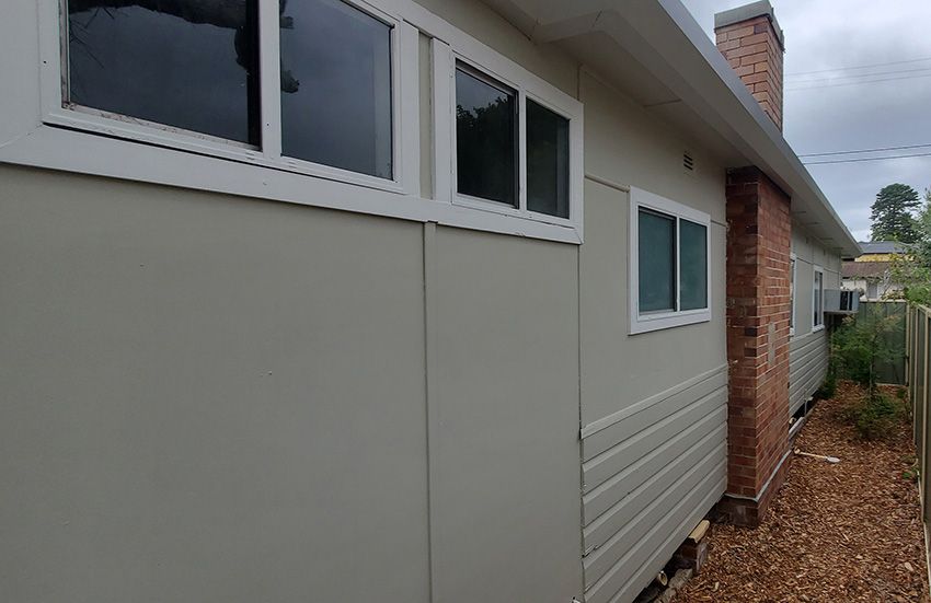 A House with a Lot of Windows on the Side of It — JWP Painting & Property Services in Newcastle, NSW